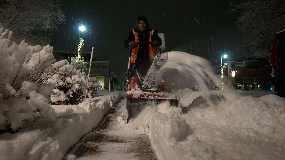 Nate's Snow & Ice employee running snow blower Nate's Snow & Ice employee running snow blower